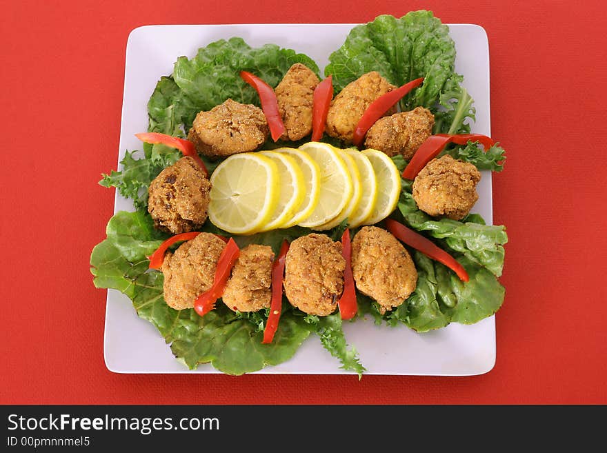 Fried appetizer platter isolated on red