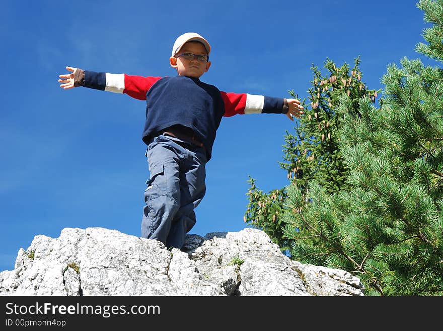 Boy on top of the rock. Boy on top of the rock