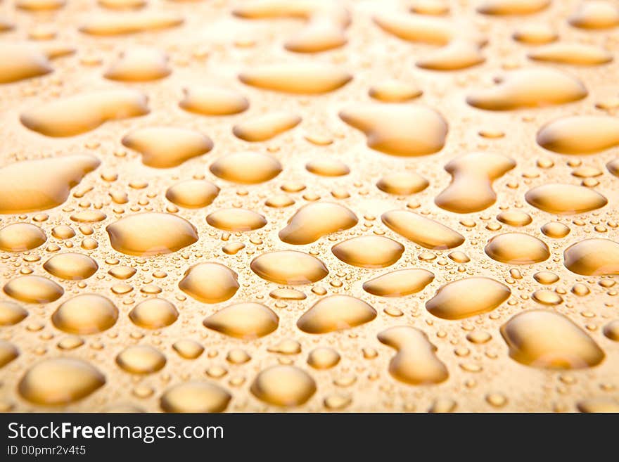 Water drops background, a golden abstract closeup with limited dof. Water drops background, a golden abstract closeup with limited dof