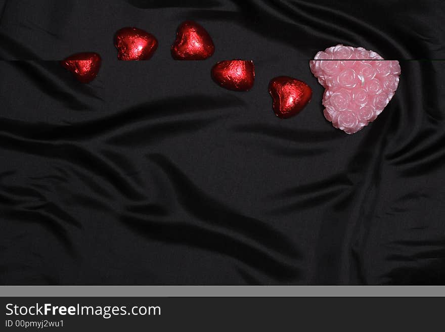 Heart-shaped stuff on balck satin