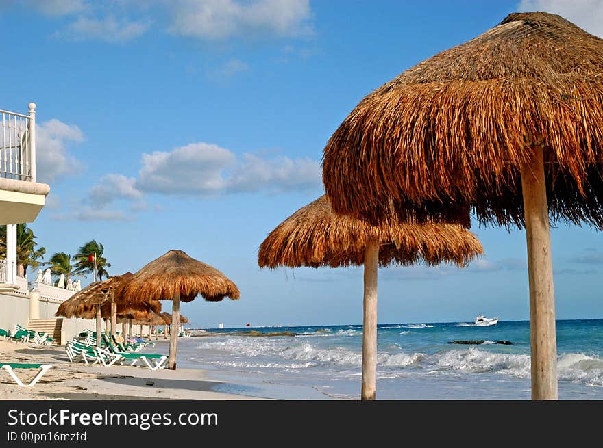 Beach green chairs , blue ocean and umbrellas 2