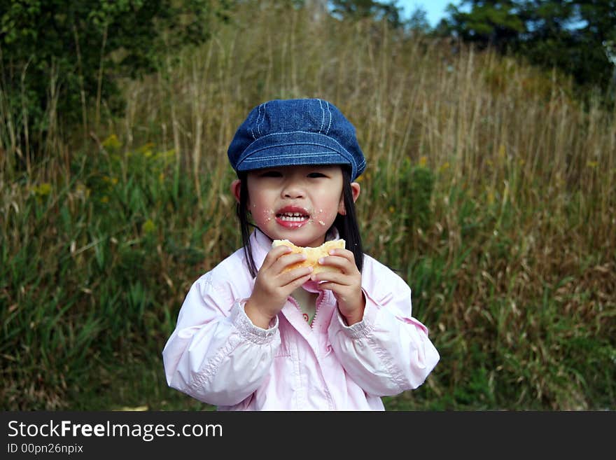 Toddler having an outdoor snack. Toddler having an outdoor snack