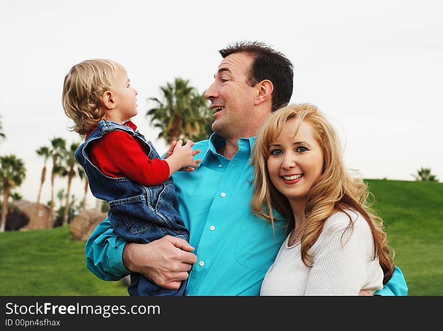 Happy couple with a child smiling and enjoying their time together