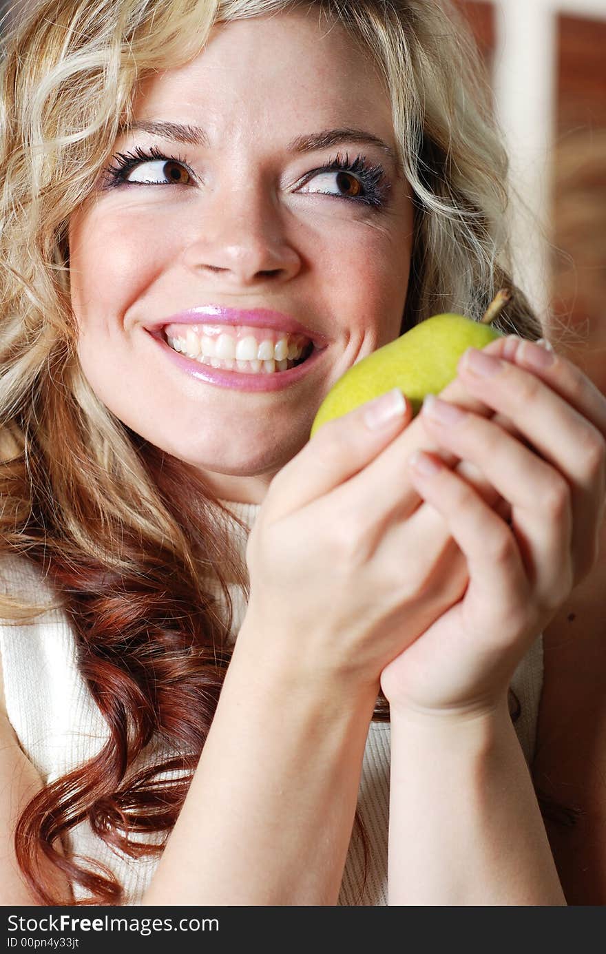 Beautiful woman is holding a fruit in her hands. Beautiful woman is holding a fruit in her hands