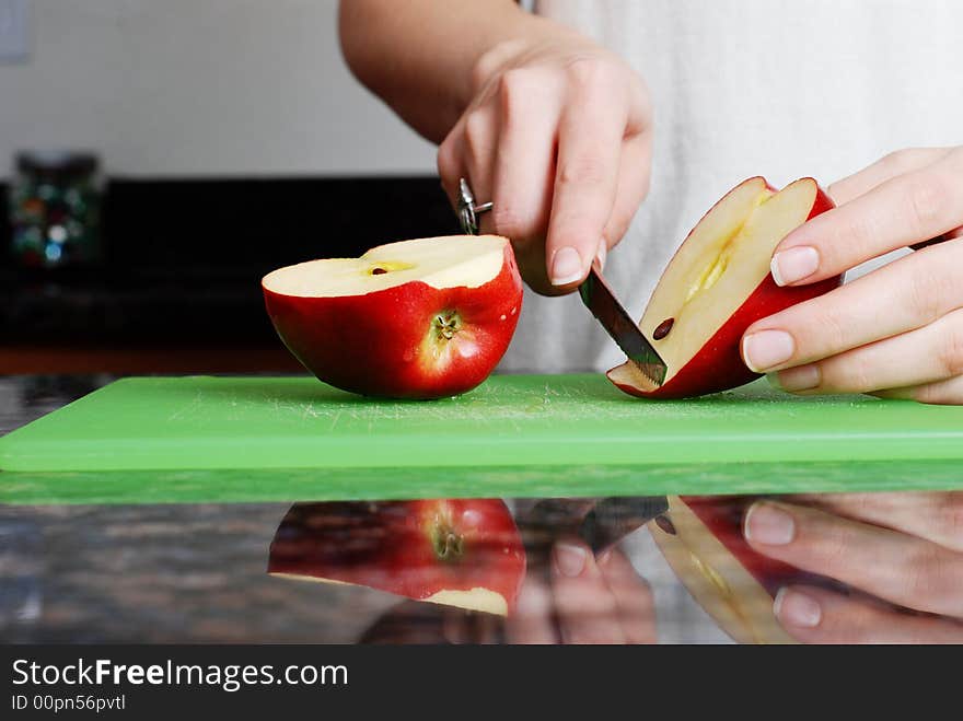 Apple on the counter symbolizes healthy living and nutritional value. Apple on the counter symbolizes healthy living and nutritional value