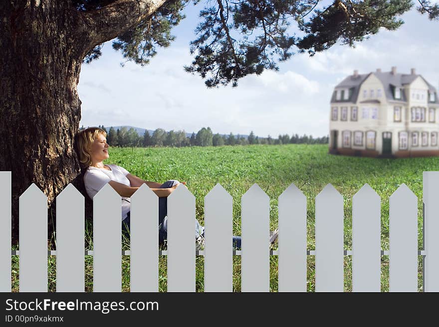 Young beauty woman sit under alone tree in field