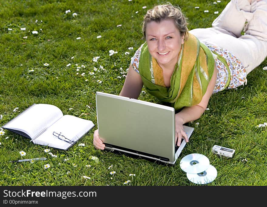 Young woman with laptop on grass. Young woman with laptop on grass