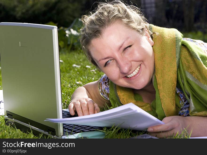 Young woman with laptop on grass. Young woman with laptop on grass