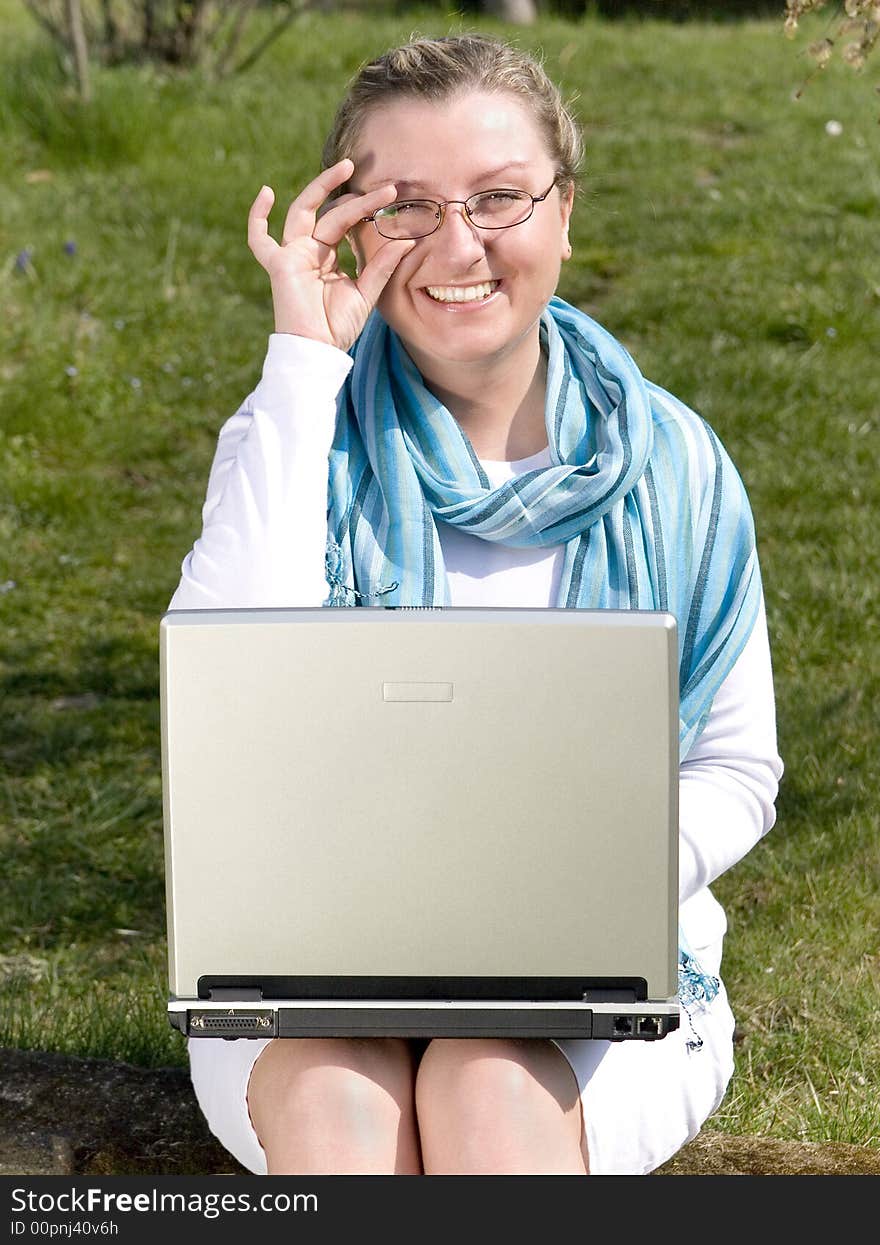 Young woman with laptop on grass. Young woman with laptop on grass