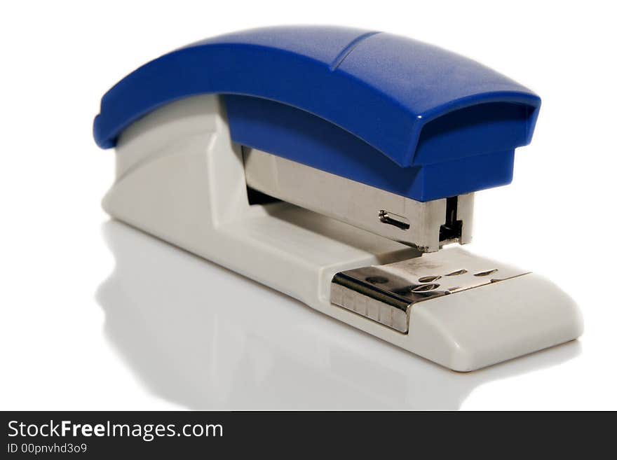 A blue plastic stapler a light background