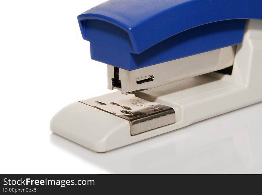 A blue plastic stapler a light background