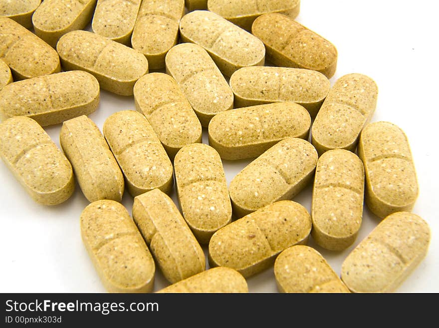 Close-up of several pills on a white background.