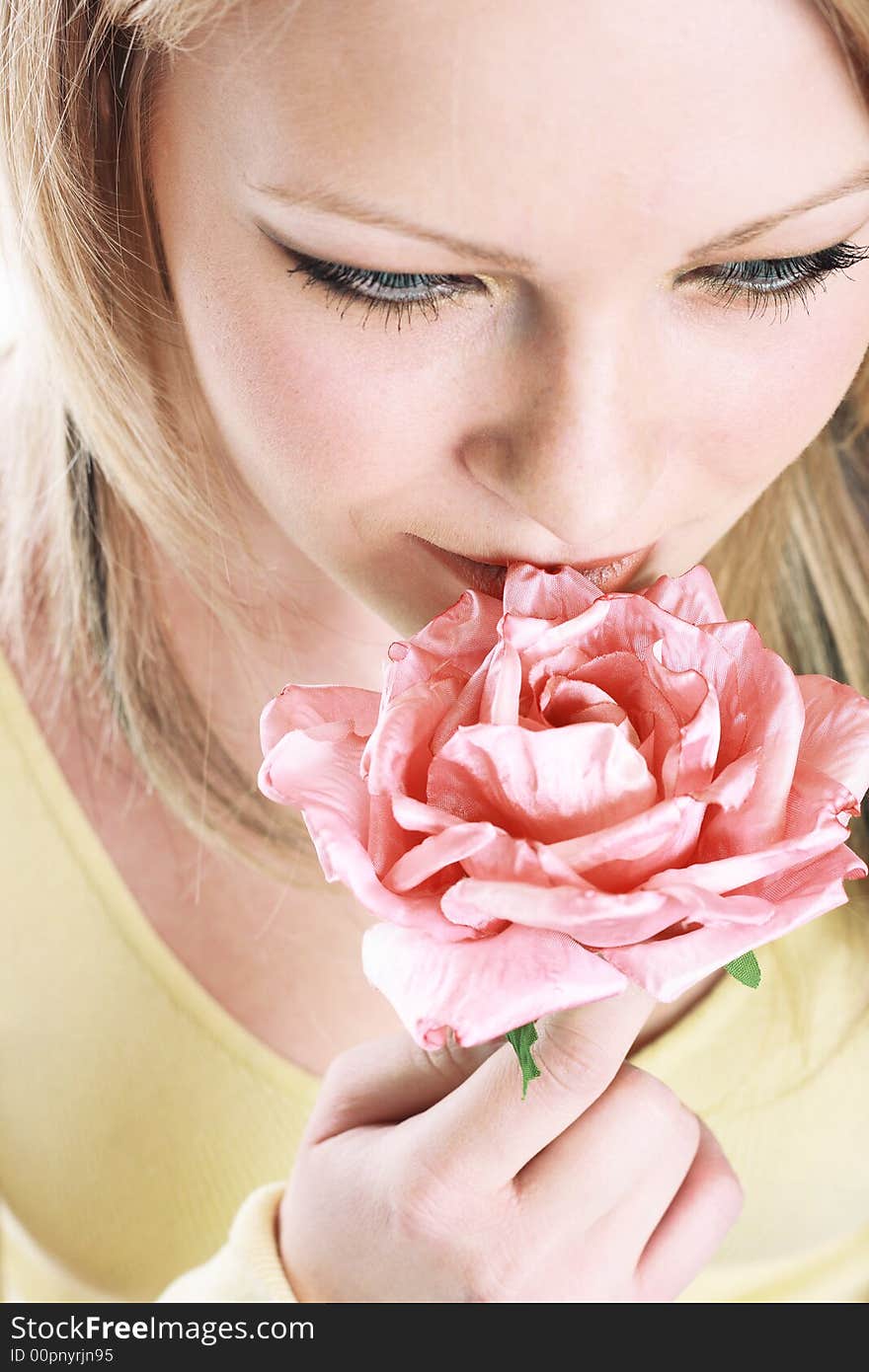 The portrait of the beautiful girl on white background with flower