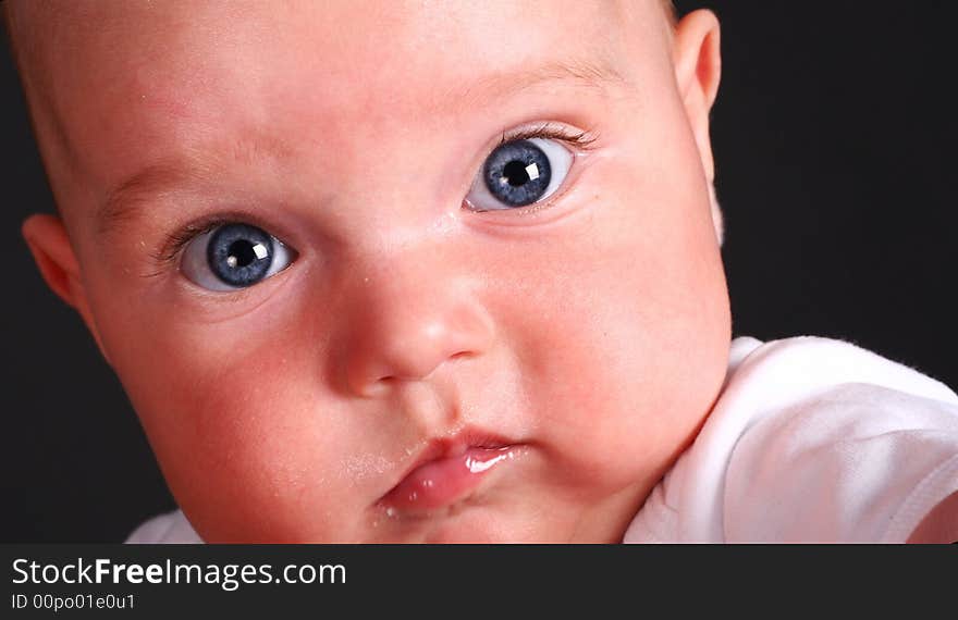 A baby watching amazed in the camera. A baby watching amazed in the camera