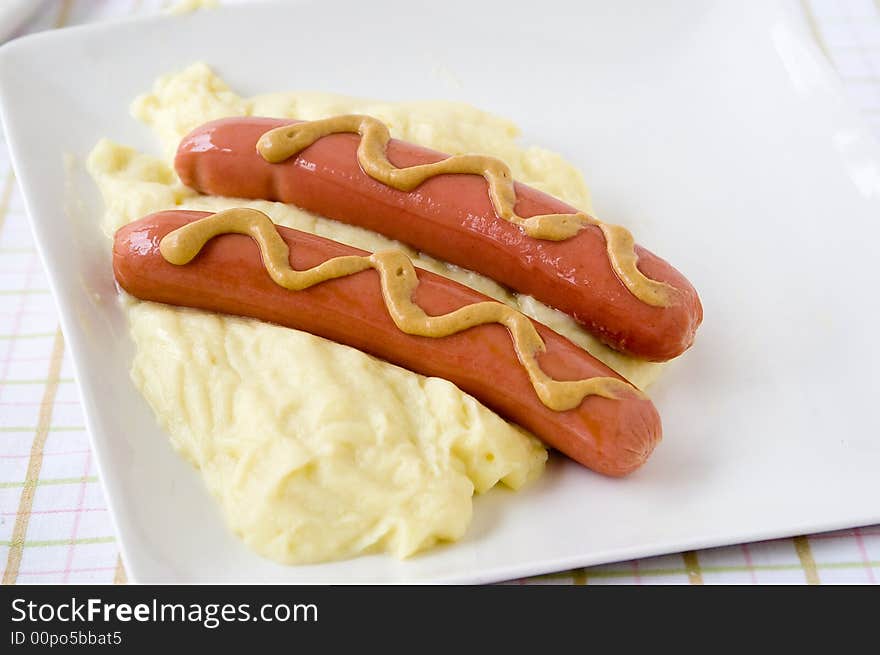 Frankfurter sausage over puree from potatoes in a dish