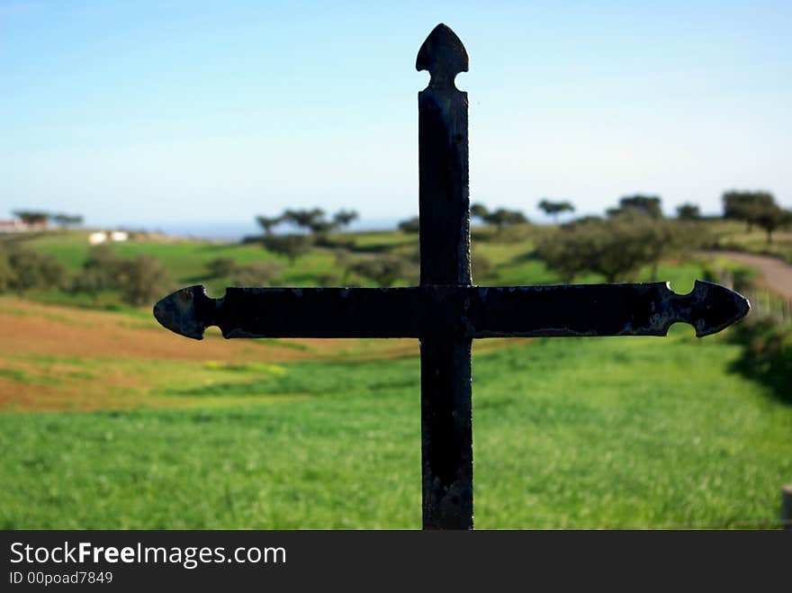 Metal cross overlooking a countryside in Portugal. Metal cross overlooking a countryside in Portugal.