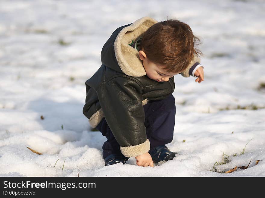 First snow. Cute toddler in snow.