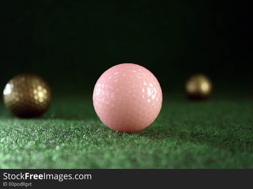 Pink golfballs with golden friends waiting for continous play