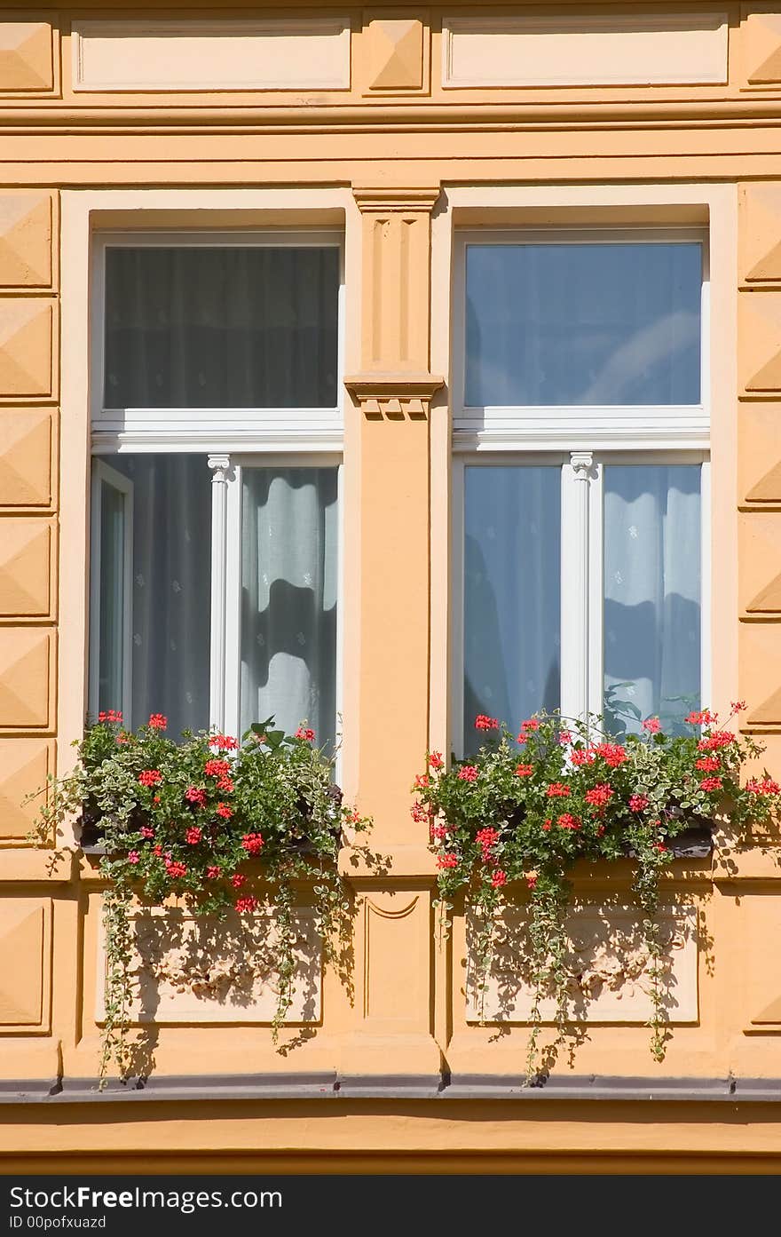 Windows of Prague building with red flowers. Windows of Prague building with red flowers.