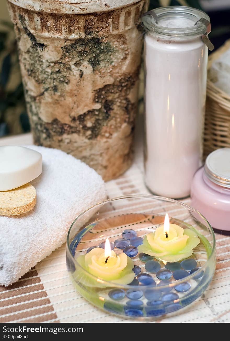 A spa composition consisting of bottle, towel, sea shell and candles submerged in a glass bowl with water. MORE SPA COMPOSITIONS ». A spa composition consisting of bottle, towel, sea shell and candles submerged in a glass bowl with water. MORE SPA COMPOSITIONS »