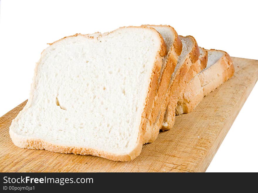 Five slices of white bread on a wooden cutting board (isolated)