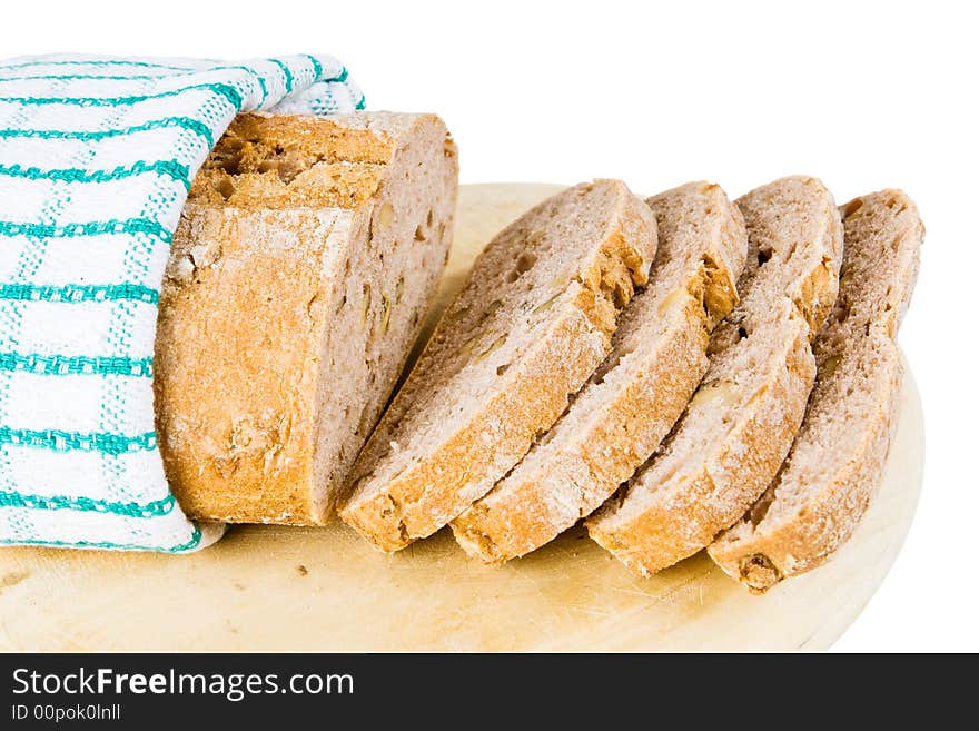 A loaf of fresh bread wrapped up in a tea towel