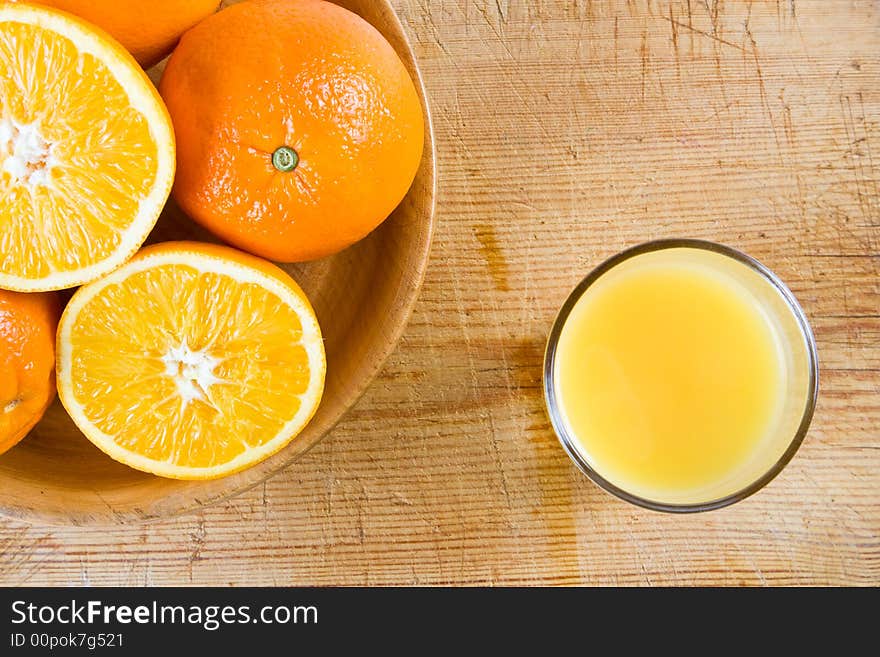 A Bowl Of Oranges On A Wooden Block