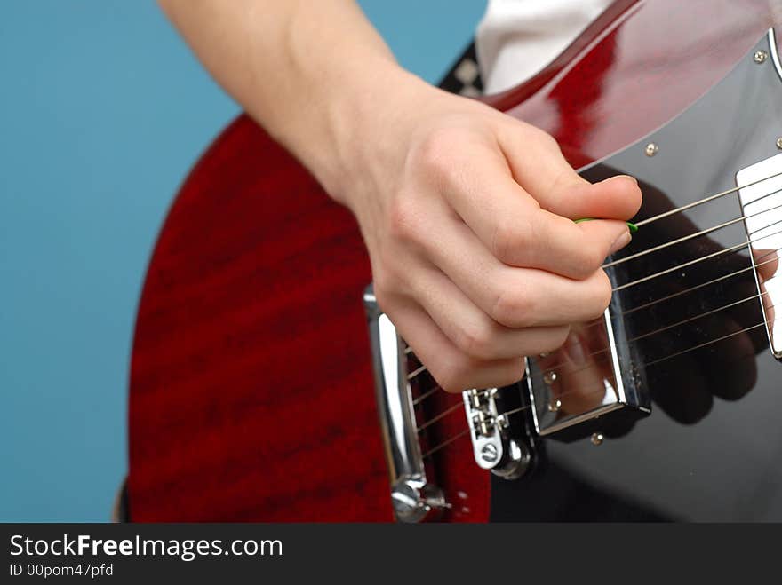 Simple shot of a teenager's hand playing a guitar; copy space can easily be extended. Simple shot of a teenager's hand playing a guitar; copy space can easily be extended