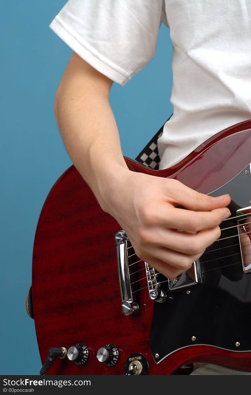 Vertical detail shot of an electric guitar player. Vertical detail shot of an electric guitar player