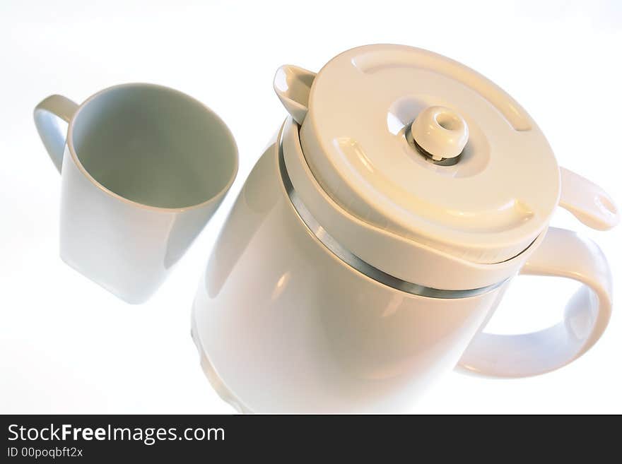 White coffee pot and mug isolated on a white background. White coffee pot and mug isolated on a white background