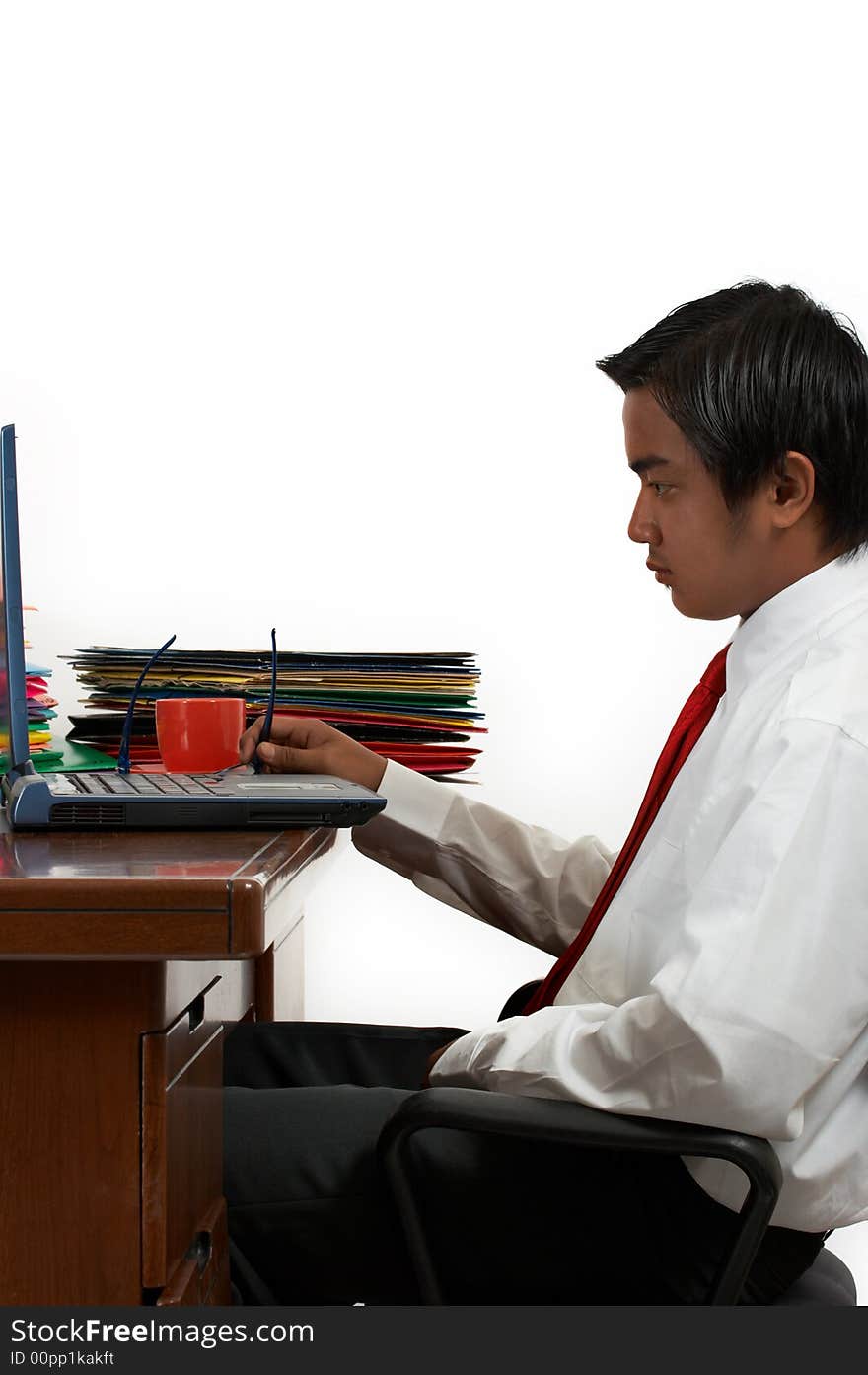 A man working on his laptop over a white background. A man working on his laptop over a white background