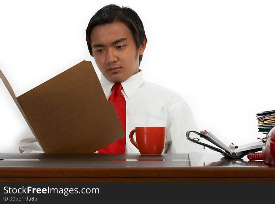 A man sitting behind an office desk. A man sitting behind an office desk