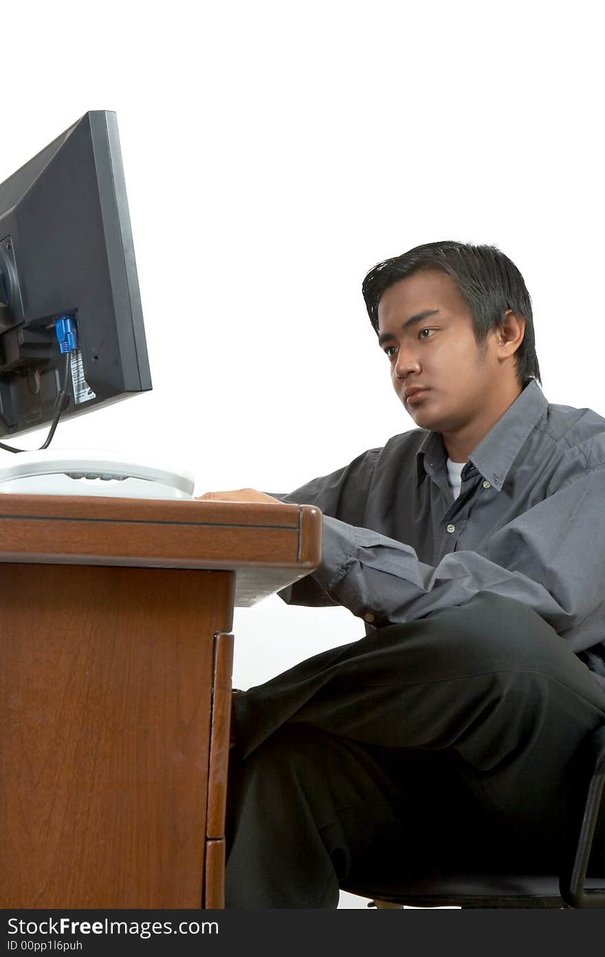 A man working on his desktop computer. A man working on his desktop computer