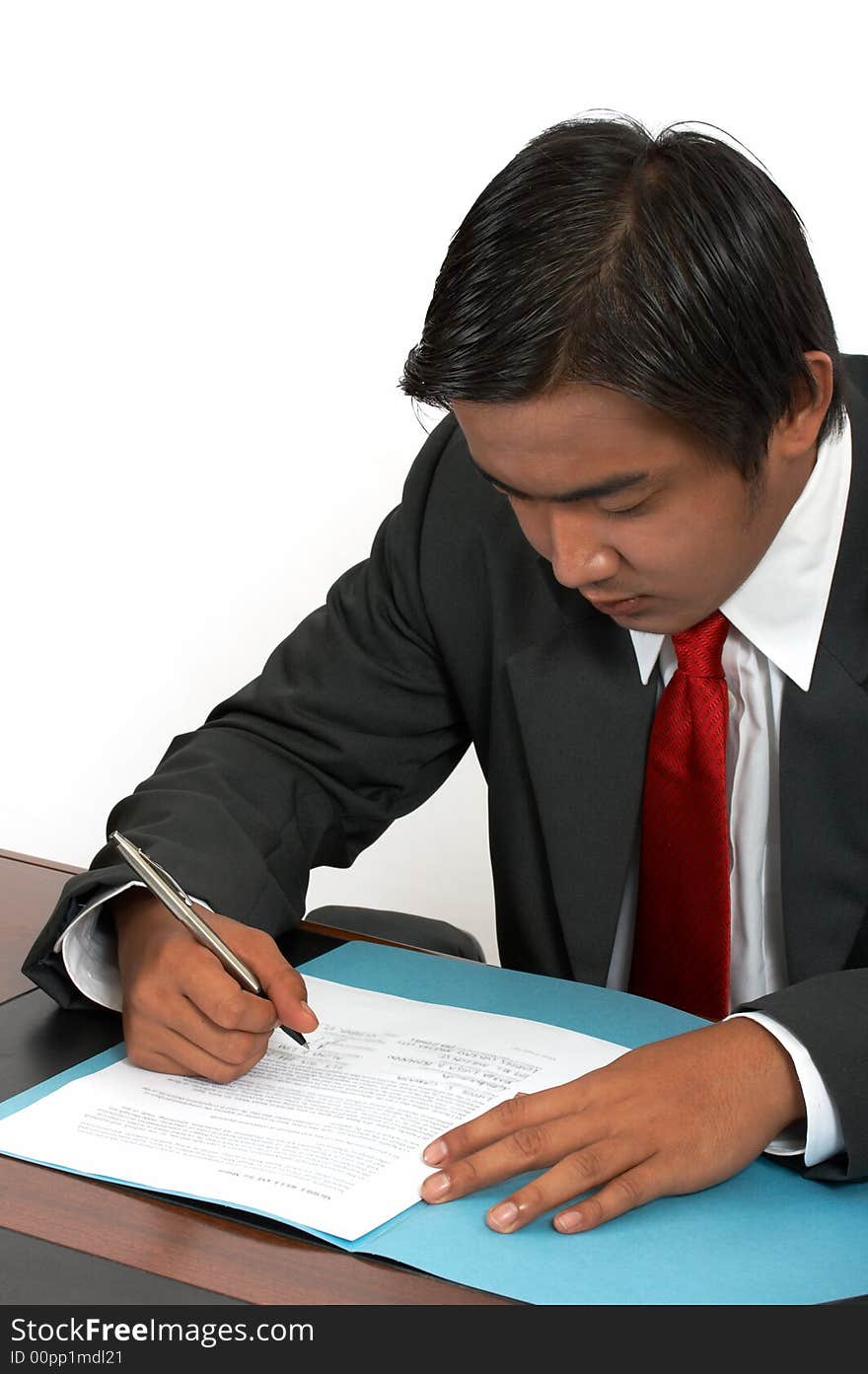 A man sitting behind his office desk. A man sitting behind his office desk