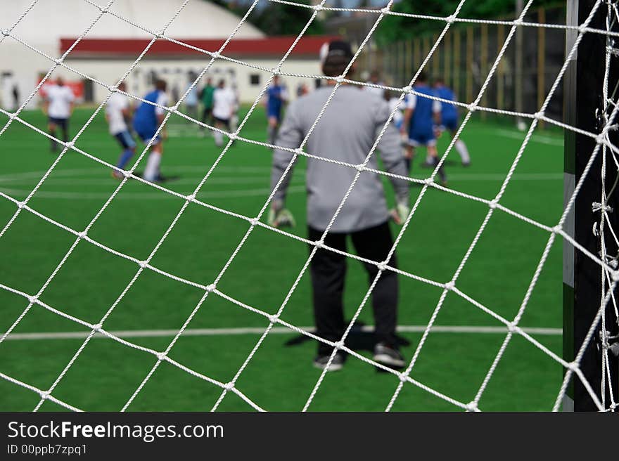 Soccer goalkeeper looking on players