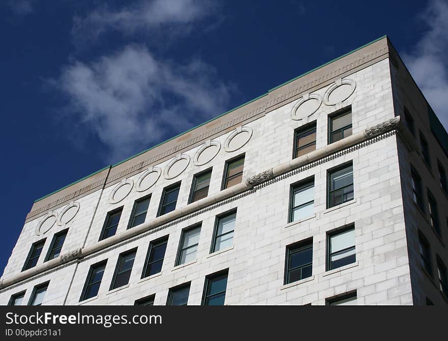 A white building features classic architectural details. A white building features classic architectural details.