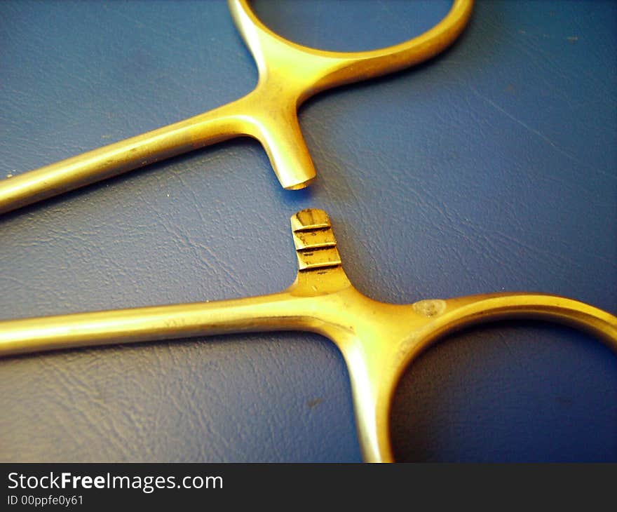 A close detail of a caliper hook on blue background