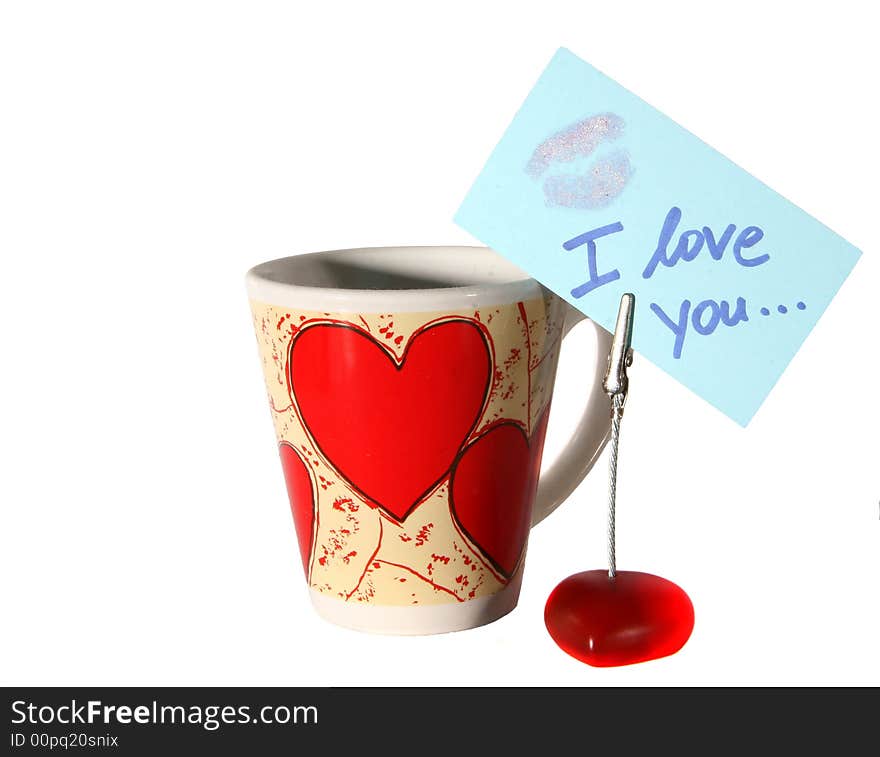 An isolated shot of a cup with hearts and an I love you note. A lot of white space for text. An isolated shot of a cup with hearts and an I love you note. A lot of white space for text.