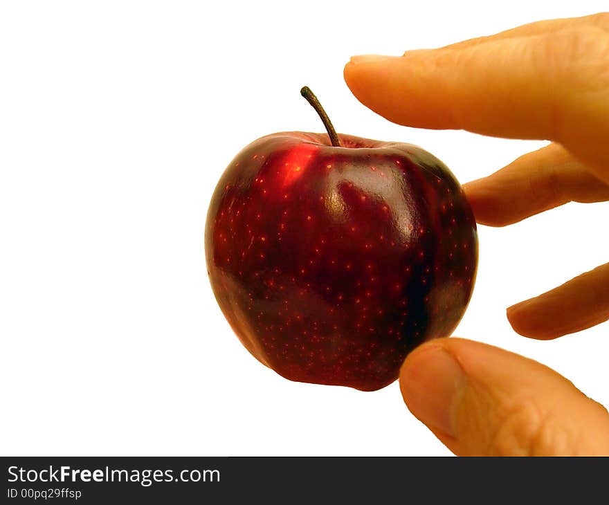 Hand stretched out towards nice red apple. Hand stretched out towards nice red apple