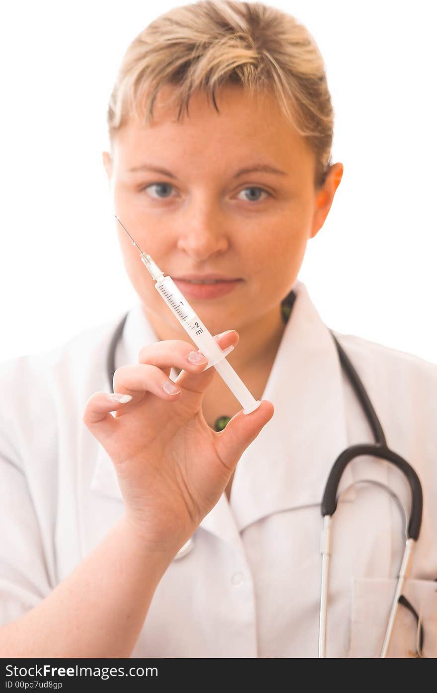 Young doctor with syringe (focus on syringe)