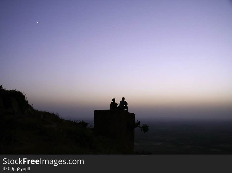 Couple chilling out on top of hill