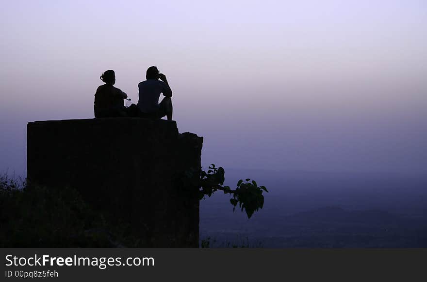 Couple chilling out on top of hill