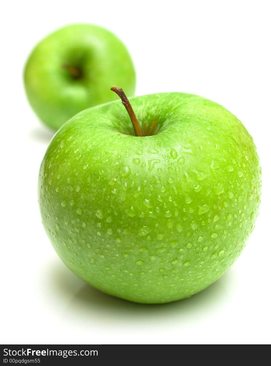 The ripe juicy apples covered by drops of water. Isolation on white, shallow DOF. The ripe juicy apples covered by drops of water. Isolation on white, shallow DOF.