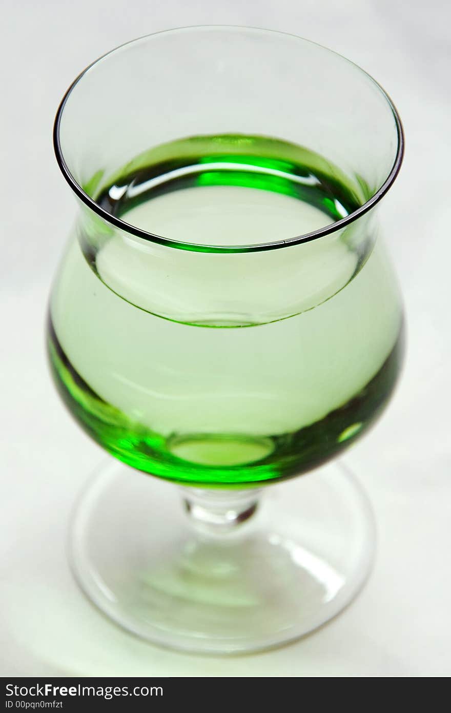 A photo of a green glass. A photo of a green glass