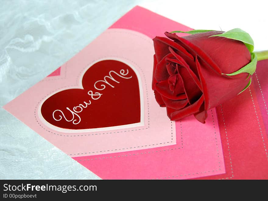 Valentine card and red rose on white lace. Valentine card and red rose on white lace.