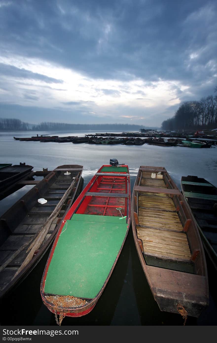 Old boat on frozen river Danube in january