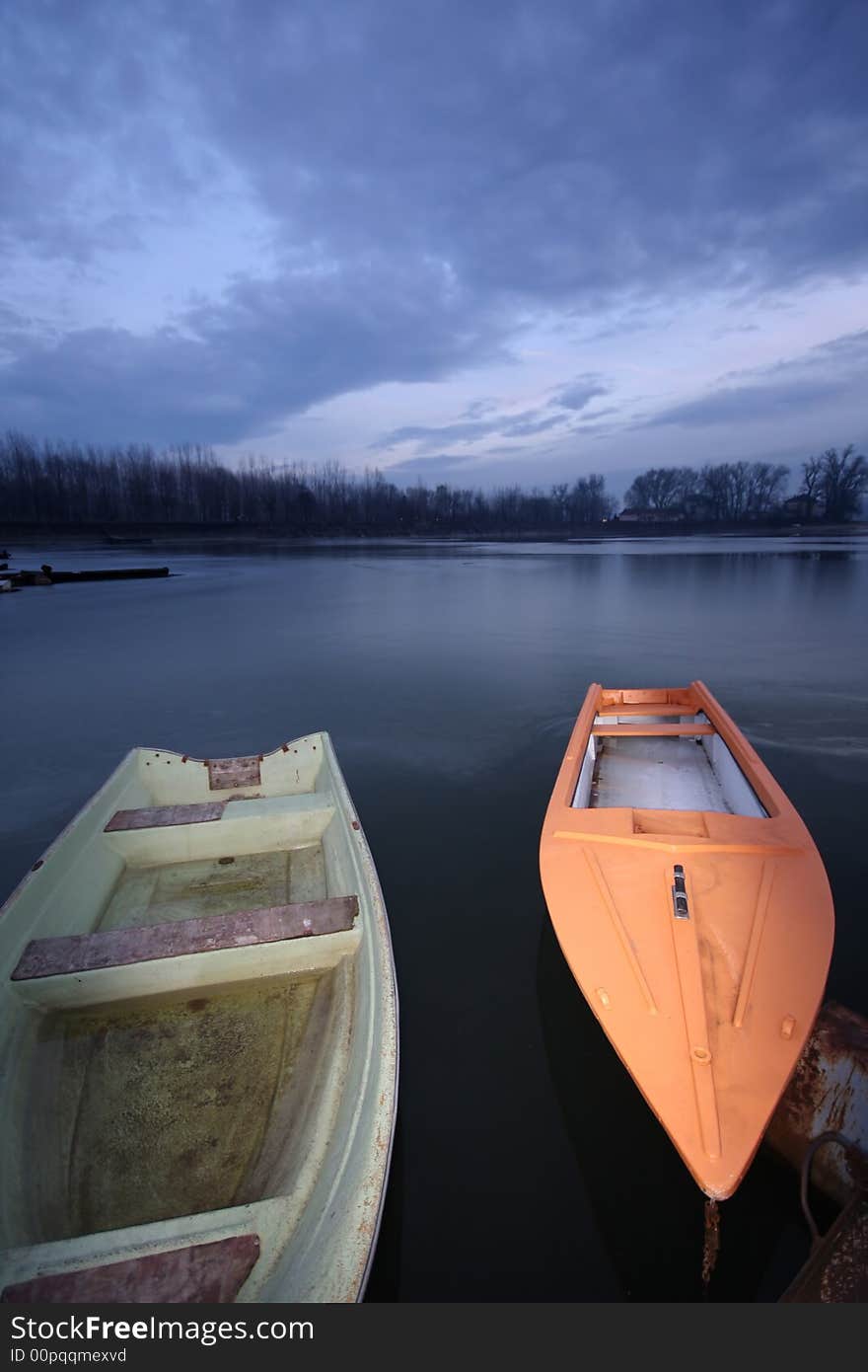 Old boat on frozen river Danube in january