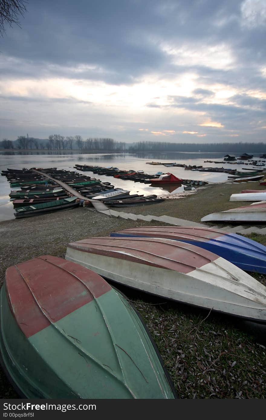 Old boat on the beach beside river Danube in january