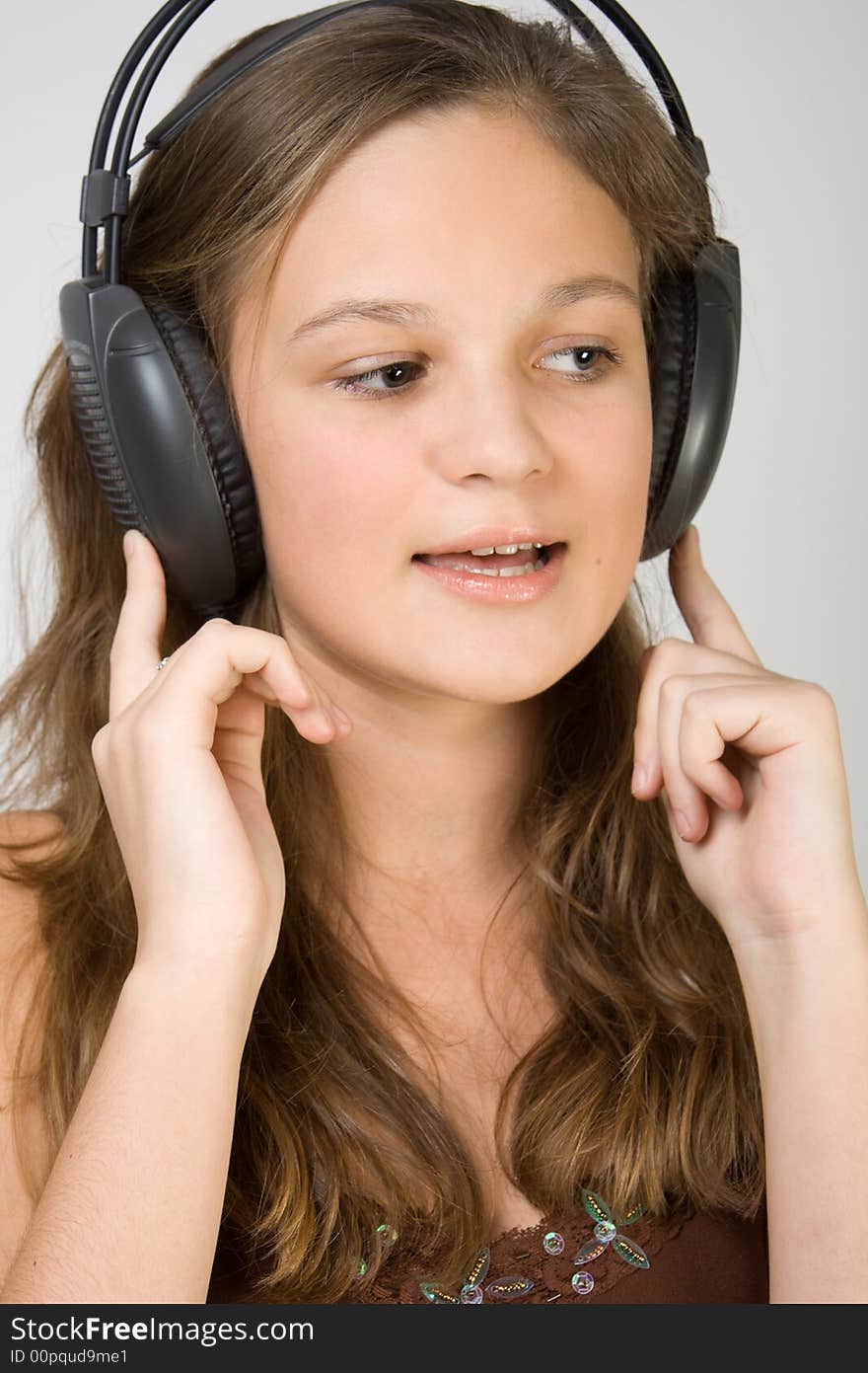 Young pretty girl listening music with headphones