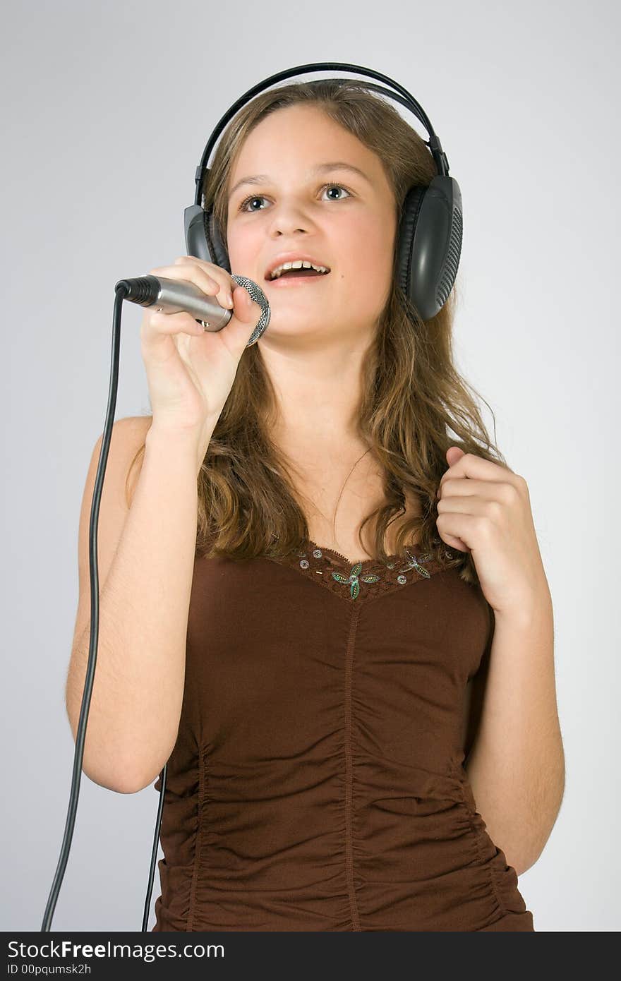 Young pretty smiling girl singing. Young pretty smiling girl singing.